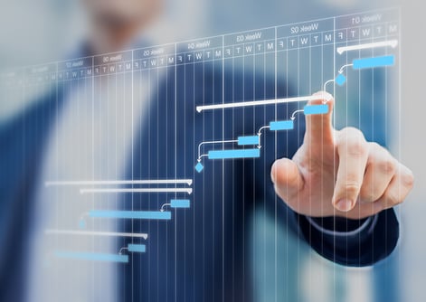 Project-manager-updating-tasks-and-milestones-progress-planning-with-Gantt-chart-scheduling-interface-on-a-virtual-screen